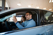 © littlewolf1989 - Happy couple testing and buying new car vehicle.