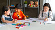 © Songkhla Studio - group of asian child little drawing with colourful pencils crayons in classroom.