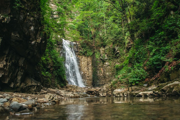  Waterfall with a lake among rocks and forest