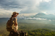 © Maygutyak - Woman enjoying sunrise from a top of mountain Batur, Bali, Indonesia.