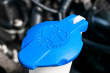 Car Windshield Wiper Cleaning Spray Water Reservoir Blue Bottle Cap In Car Engine Space. Car Detailing. Car Inside. Installed Front Under The Hood Near Car Engine.