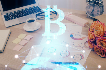 Double exposure of blockchain and crypto economy theme hologram and table with computer background. Concept of bitcoin cryptocurrency.