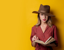 Woman In 1940s Style Clothes With Book