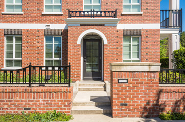 Wall Mural - Entrance of new apartment building with concrete steps and brick fence in front