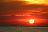 Fototapeta Zachód słońca - sunset on red yellow sky back soft evening cloud over horizon sea