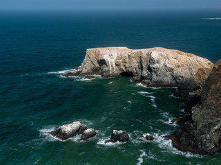 Rock formations at Marin Headlands featuring blue sky and ocean