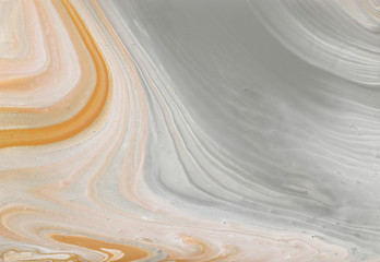 photography of abstract marbleized effect background. gray, gold and white creative colors