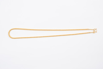 Gold chain necklace isolated on white background.