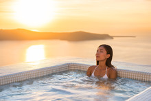 Spa Hotel Luxury Relax Jacuzzi Therapy Pool Asian Woman Relaxing In Resort Hot Tub Outside On Private Room Balcony Sunset Over Sea. Europe Honeymoon Vacation Relaxation Wellness Pampering.