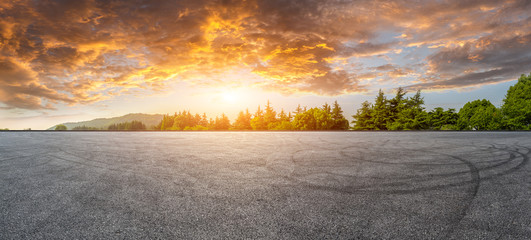 Wide race track and green woods nature landscape at sunset