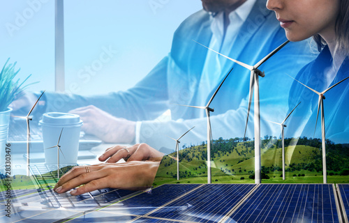 Cuadros en Lienzo Double exposure graphic of business people working over wind turbine farm and green renewable energy worker interface