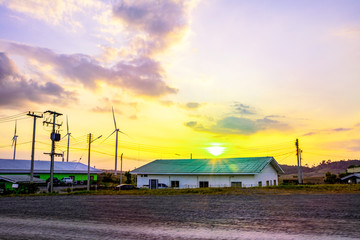 Wall Mural - landscape mountain view with windmills on the hill with sunset sky, wind turbine generator to build 