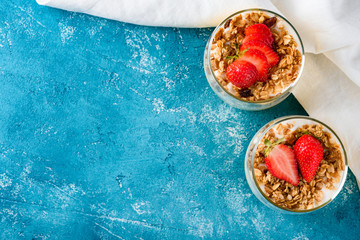 Flat Lay berry dessert with yogurt and muesli baked on red background with copy space