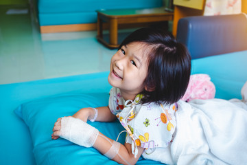 Wall Mural - Illness asian child admitted in hospital with saline iv drip on hand.  Health care stories.