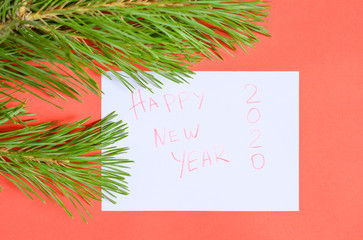 Happy new year 2020 - inscription on paper in a frame of pine branches. 2020 coming New year