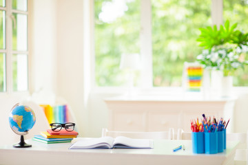 Back to school. Kids desk with books, globe.