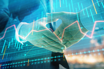 Double exposure of financial chart on cityscape background with two businessmen handshake. Concept of financial analysis and investment opportunities