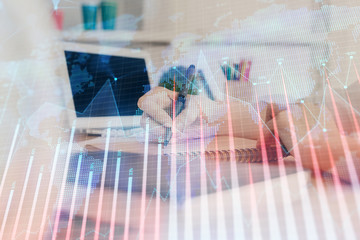 Financial graph displayed on woman's hand taking notes background. Concept of research. Double exposure