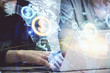 © peshkova - Forex graph with businessman typing on computer in office on background. Concept of analysis. Double exposure.
