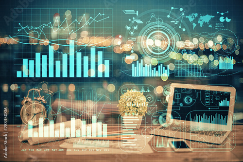 Double exposure of graph and financial info and work space with computer background Fototapet