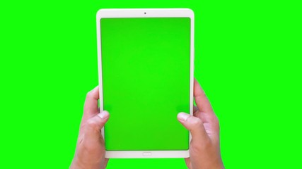 men's hands swipe on the surface with a tablet. green screen footage. 4k. top view.