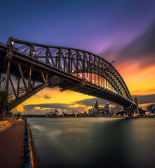 Wall Mural - Sunset skyline of Sydney downtown with city lights and Harbour Bridge