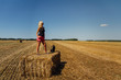 © Space Creator - Portrait of  beauty blonde caucasian woman standing on redneck of straw with backpack