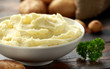 © grinchh - Mashed potatoes in white bowl on wooden rustic table. Healthy food
