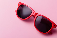 Stylish Red Sunglasses Closeup On Pink Background, Flat Lay. Wayfarer Shape Sunglasses