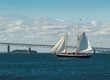 Two-masted sailing yacht in front of Newport Bridge, Rhode Island