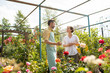 © pressmaster - Owner of flower shop or garden center talking to one of clients