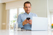 © Krakenimages.com - Middle age man working with laptop and using smartphone