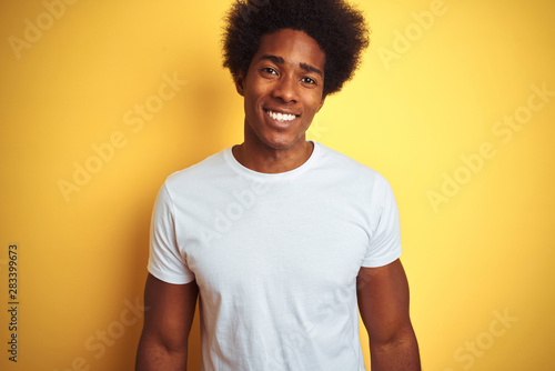 American Man With Afro Hair Wearing White T Shirt Standing Over