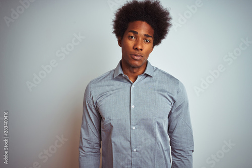 Young African American Man With Afro Hair Wearing Grey Shirt Over