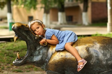 Wall Mural - Portrait of a three year old girl on the summer playground