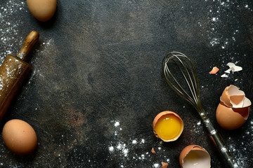 Culinary background with ingredients for baking : milk, butter,sugar, dough and egg . Top view with copy space.