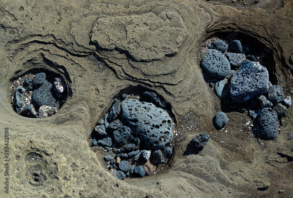 Tuff Wave Three bore holes in volcanic tuff containing scoria that have been ...