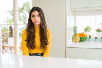 Sticker - Young beautiful woman at home on white table skeptic and nervous, frowning upset because of problem. Negative person.