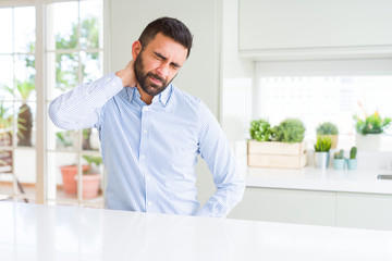 Canvas Print - Handsome hispanic business man Suffering of neck ache injury, touching neck with hand, muscular pain