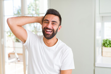 Wall Mural - Handsome man smiling cheerful with a big smile on face showing teeth, positive and happy expression