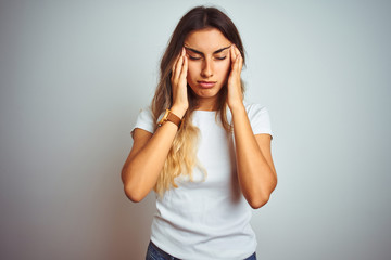 Poster - Young beautiful woman wearing casual white t-shirt over isolated background with hand on headache because stress. Suffering migraine.