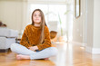 © Krakenimages.com - Beautiful young girl kid sitting on the floor at home with serious expression on face. Simple and natural looking at the camera.