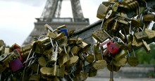 Closeup View Of Many Padlocks With Names Of Lovers On Bridge In Paris, Eiffel Tower In Background