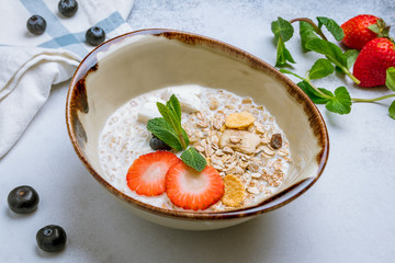 Wall Mural - Oatmeal with berries on grey background