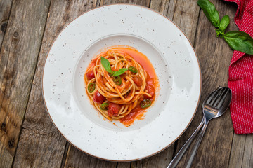 Wall Mural - Pasta linguini arabiata on old wooden table