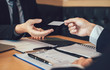 © wutzkoh - Employees submit business cards to job interviewers and interested in joining him contact immediately.