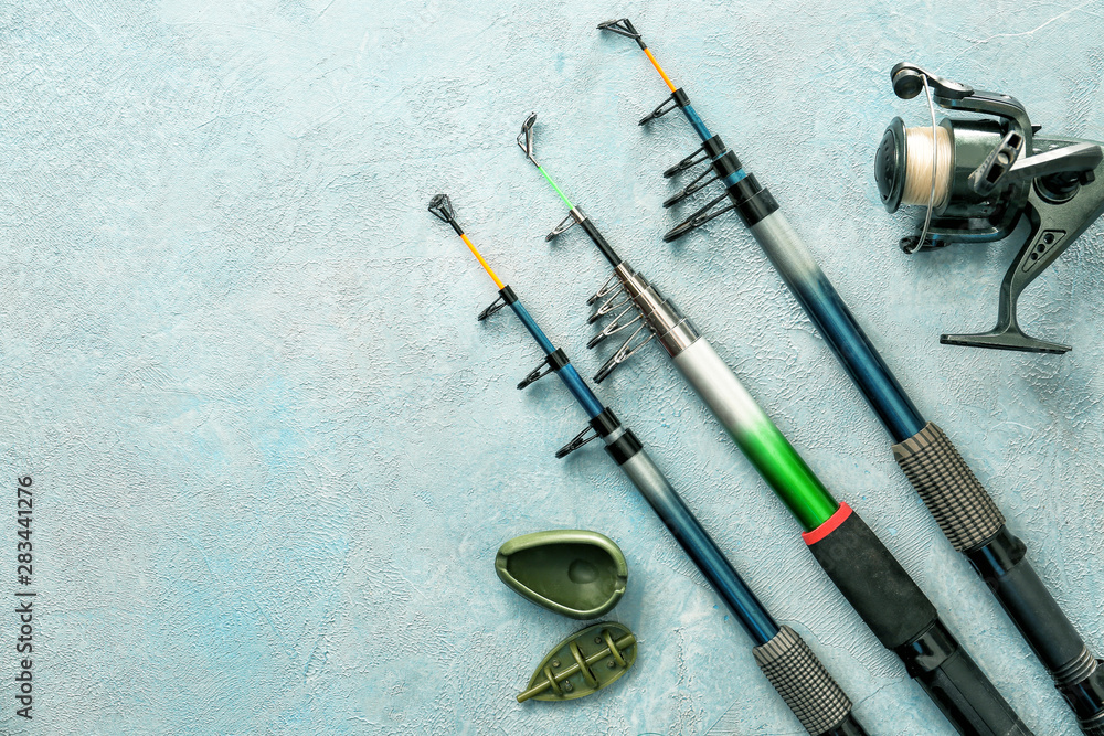 Different fishing equipment on color background