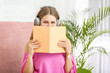 © Pixel-Shot - Young woman listening to audiobook at home
