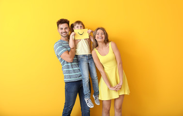 Poster - Portrait of happy family with drawn smile on sheet of paper against color background