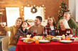 © Pixel-Shot - Happy family taking selfie during Christmas dinner at home